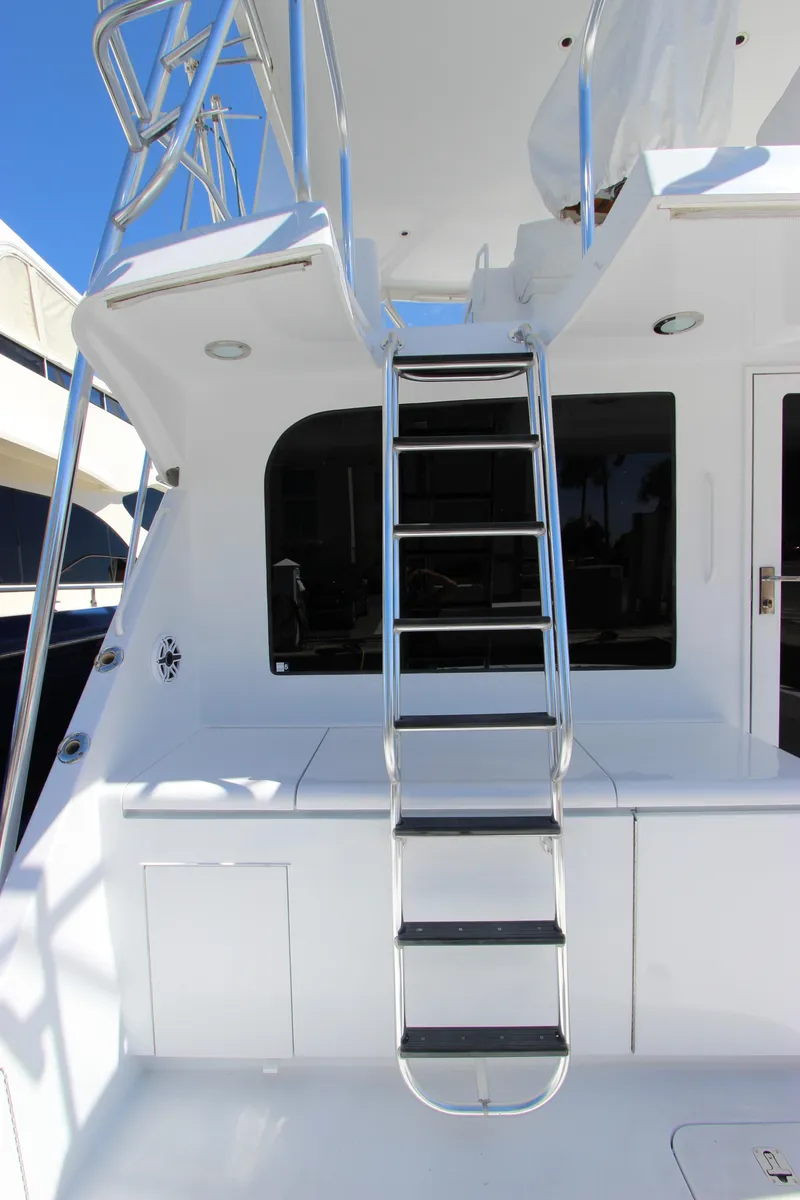 Slide: The Image of 2004 Hatteras 60 Convertible yacht with sleek ladder and modern design. - 34