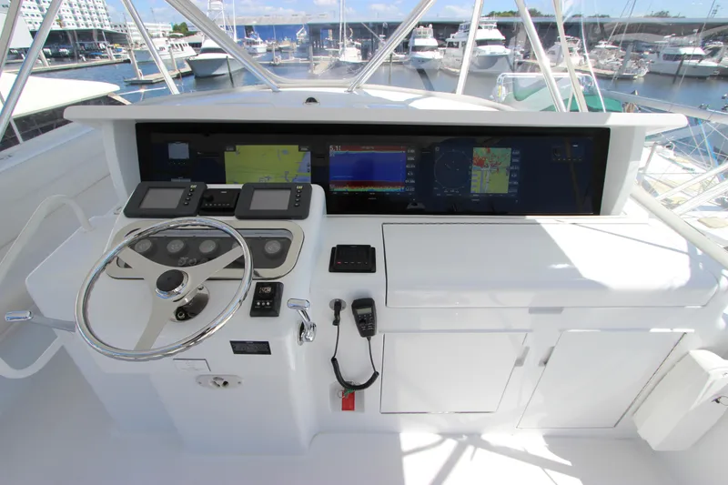 Slide: The Image of Helm of 2004 Hatteras 60 Convertible yacht with navigation screens and controls. - 40