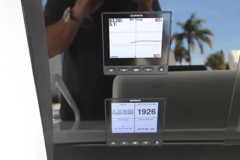 Slide: The Image of Garmin displays on a 2004 Hatteras 60 Convertible yacht, showing navigation and temperature data. - 42
