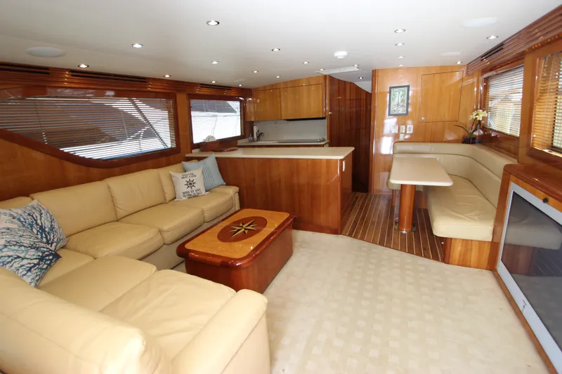 Slide: The Image of Luxurious interior of 2004 Hatteras 60 Convertible yacht with beige seating and wooden accents. - 47