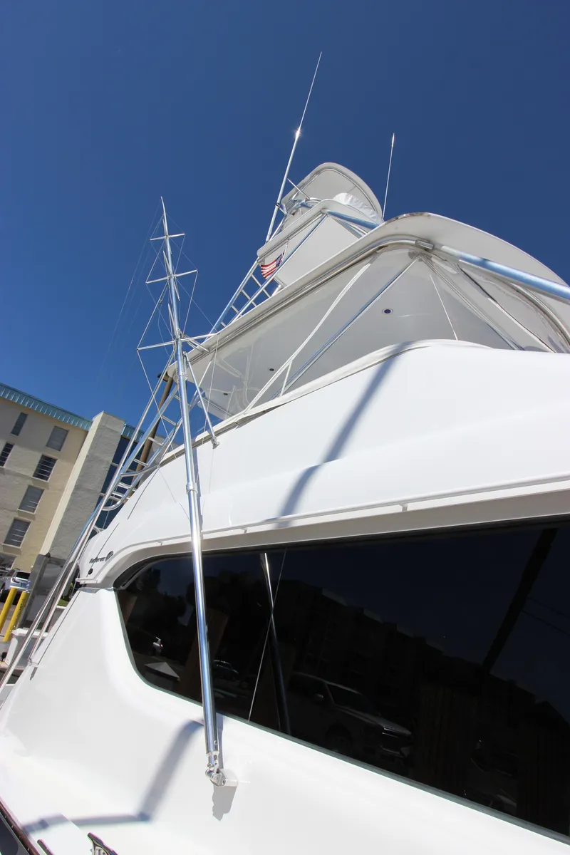 Slide: The Image of 2004 Hatteras 60 Convertible yacht against a clear blue sky. - 8