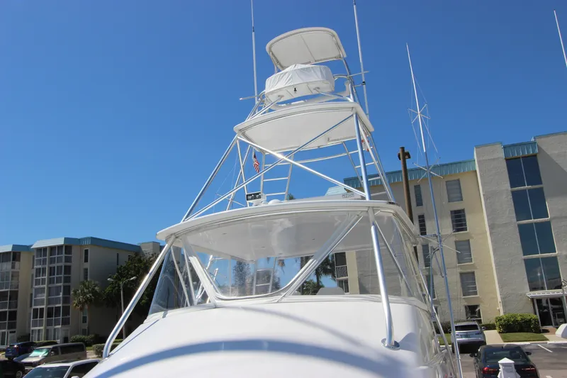 Slide: The Image of 2004 Hatteras 60 Convertible yacht with tower against a clear blue sky. - 9