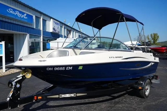 The Image of 2008 Sea Ray 175 Sport boat on trailer, parked outside dealership. - 1