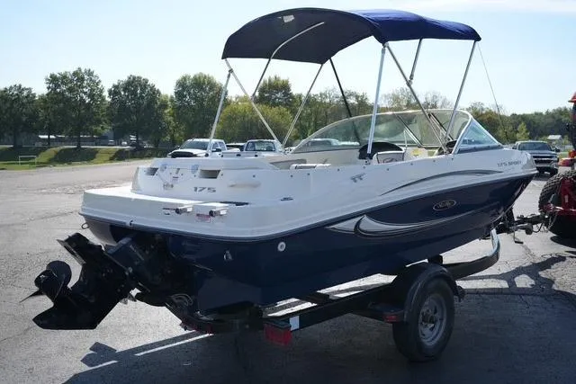 Slide: The Image of 2008 Sea Ray 175 Sport boat on trailer with blue canopy in outdoor setting. - 3