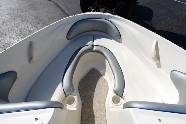Slide: The Image of 2008 Sea Ray 175 Sport boat interior with cushioned seating and carpeted floor. - 6