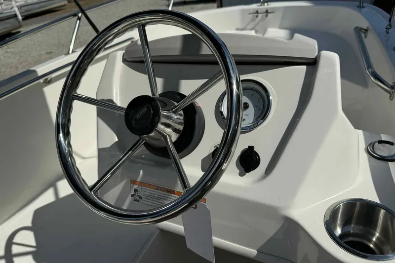 Slide: The Image of 2024 Boston Whaler 130 Super Sport steering wheel and dashboard close-up. - 7