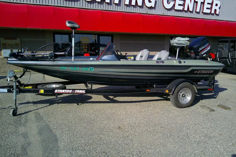 Slide: The Image of 1998 Stratos 273 V boat on trailer outside a boating center. - 11