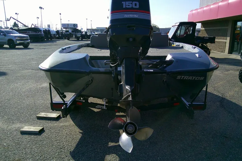 Slide: The Image of 1998 Stratos 273 V boat with FastStrike 150 engine on trailer in parking lot. - 5
