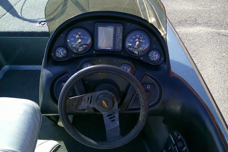 Slide: The Image of Dashboard of a 1998 Stratos 273 V boat with steering wheel and gauges. - 8