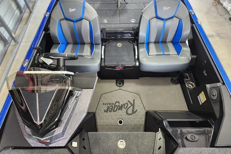 Slide: The Image of 2025 Ranger Z520 boat interior with blue and gray seats, steering wheel, and console. - 13