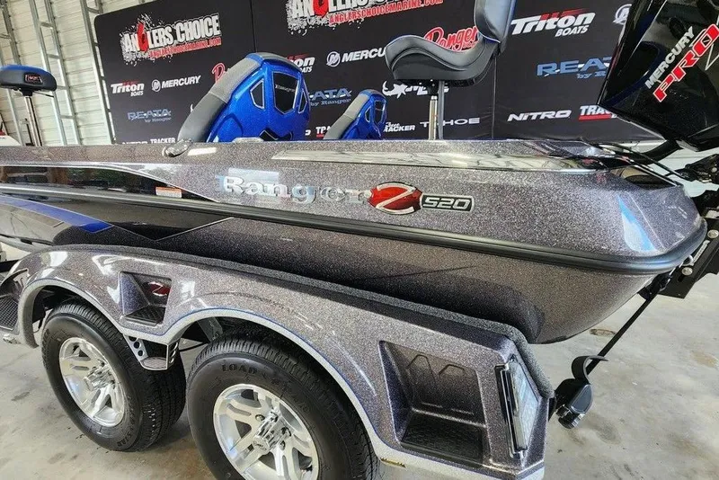 Slide: The Image of 2025 Ranger Z520 boat with metallic finish and dual seats in a showroom. - 2