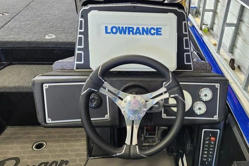 Slide: The Image of 2025 Ranger Z520 boat dashboard with Lowrance display and steering wheel. - 6