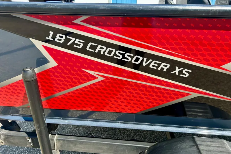 Slide: The Image of 2021 Lund 1875 Crossover XS boat with bold red and black graphics. - 1