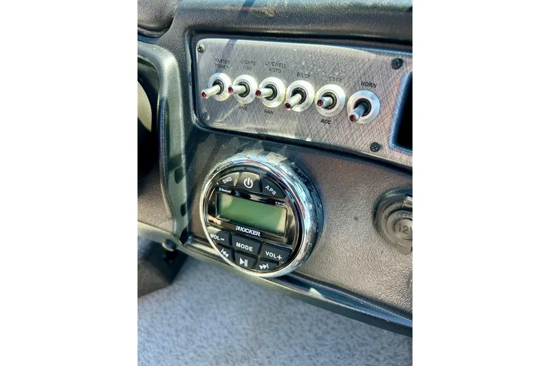 Slide: The Image of Control panel of 2021 Lund 1875 Crossover XS boat with switches and Kicker audio system. - 11