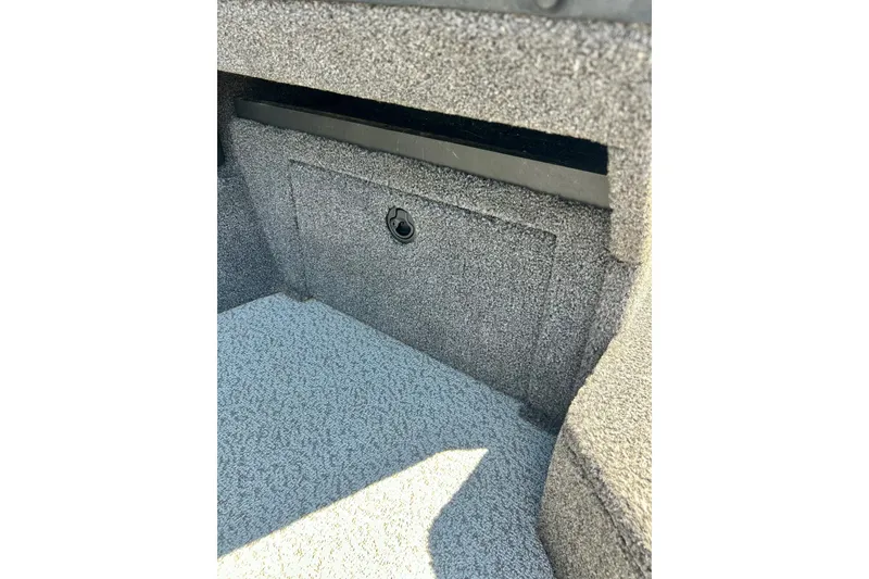 Slide: The Image of 2021 Lund 1875 Crossover XS boat interior storage compartment, carpeted finish. - 17