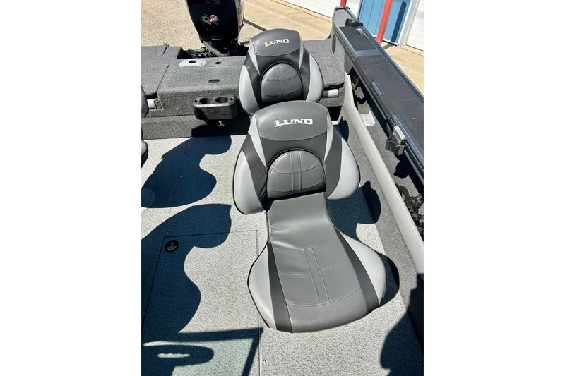 Slide: The Image of 2021 Lund 1875 Crossover XS boat interior with gray seating and logo. - 23