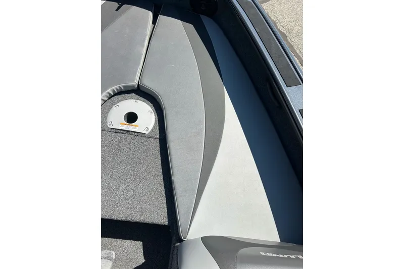 Slide: The Image of Interior view of 2021 Lund 1875 Crossover XS boat, featuring gray seating and flooring. - 25