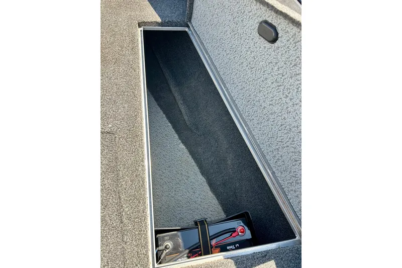 Slide: The Image of 2021 Lund 1875 Crossover XS storage compartment with battery and switch. - 27