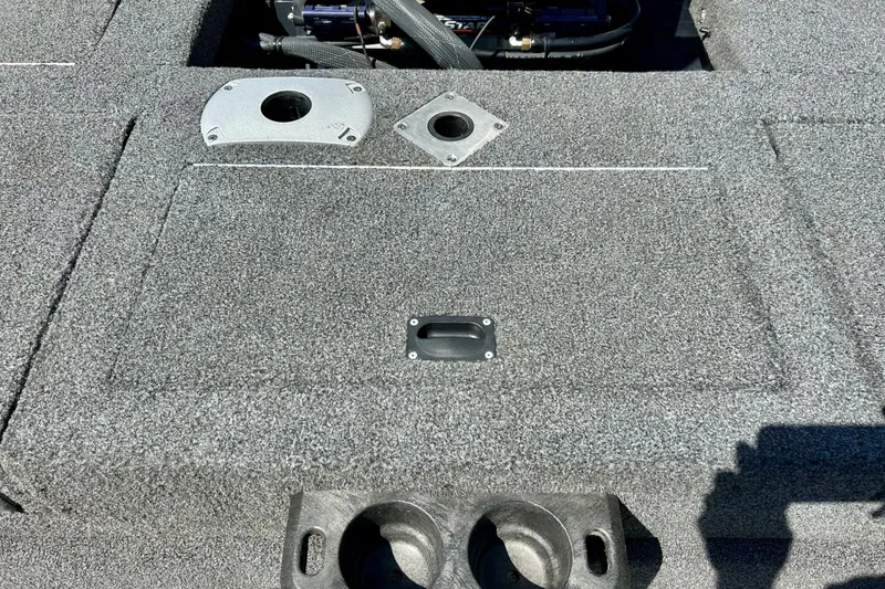 Slide: The Image of 2021 Lund 1875 Crossover XS boat interior with carpeted deck and storage compartments. - 33