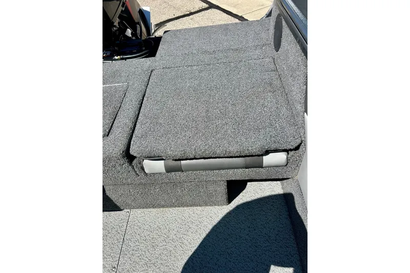 Slide: The Image of 2021 Lund 1875 Crossover XS boat interior with gray carpeted seating. - 35