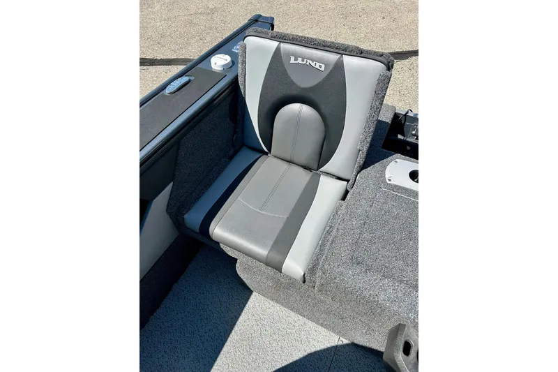 Slide: The Image of 2021 Lund 1875 Crossover XS boat seat, gray and black design, outdoor setting. - 38