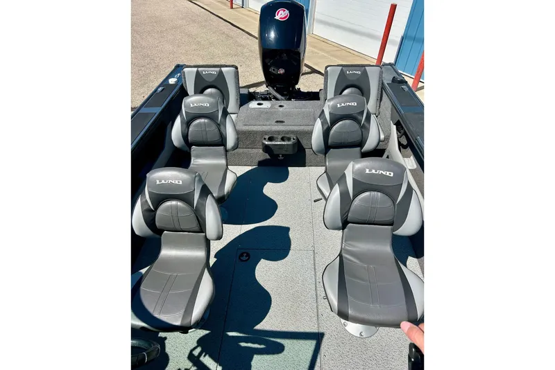 Slide: The Image of 2021 Lund 1875 Crossover XS boat interior with four gray seats and motor. - 40