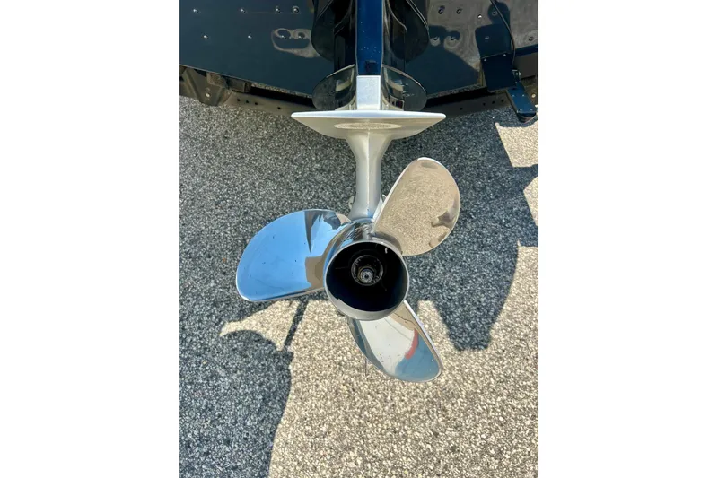 Slide: The Image of Propeller of 2021 Lund 1875 Crossover XS boat on pavement background. - 43