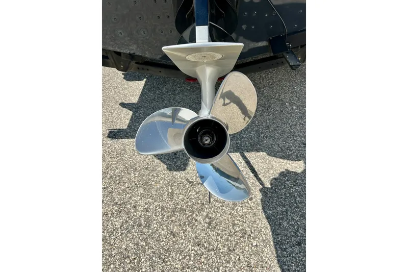 Slide: The Image of Shiny propeller of 2021 Lund 1875 Crossover XS boat on pavement background. - 52
