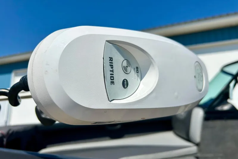 Slide: The Image of Close-up of Riptide motor on 2021 Lund 1875 Crossover XS boat under clear blue sky. - 54