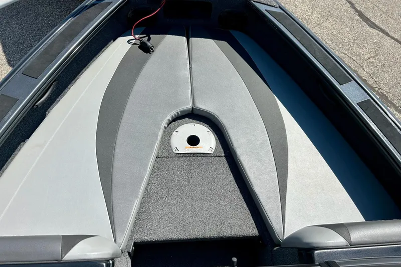 Slide: The Image of 2021 Lund 1875 Crossover XS boat interior with cushioned seating and storage. - 9