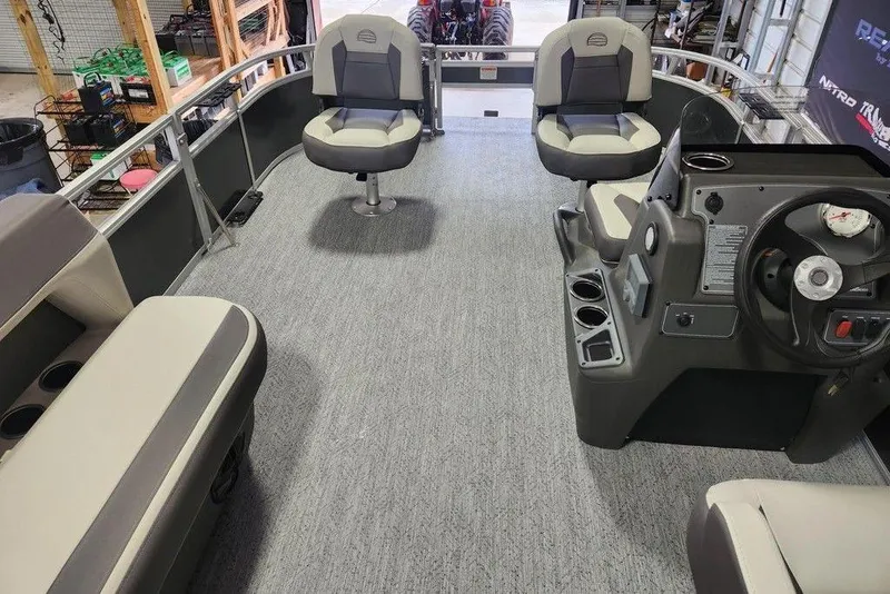 Slide: The Image of 2026 Sun Tracker Bass Buggy 16 XL Select interior with seating and steering console. - 2