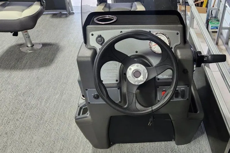 Slide: The Image of 2026 Sun Tracker Bass Buggy 16 XL Select pontoon boat interior with seating and helm. - 5