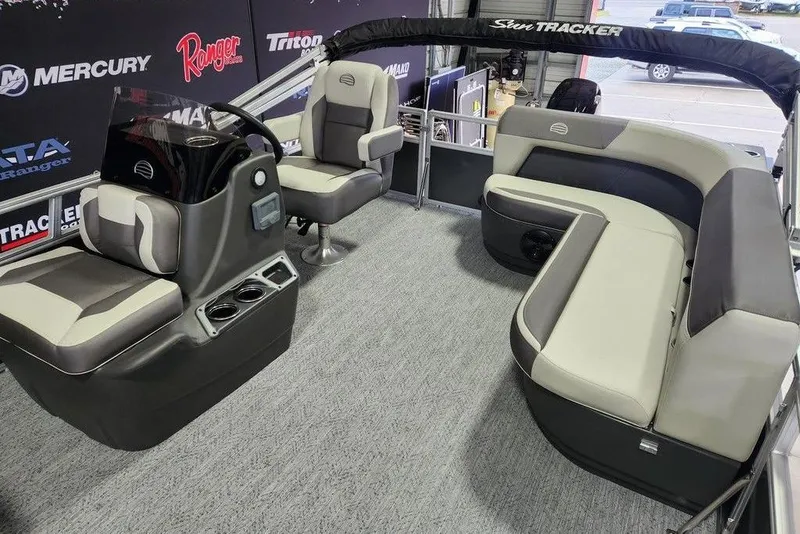 Slide: The Image of 2026 Sun Tracker Bass Buggy 16 XL Select pontoon boat on trailer in showroom. - 8