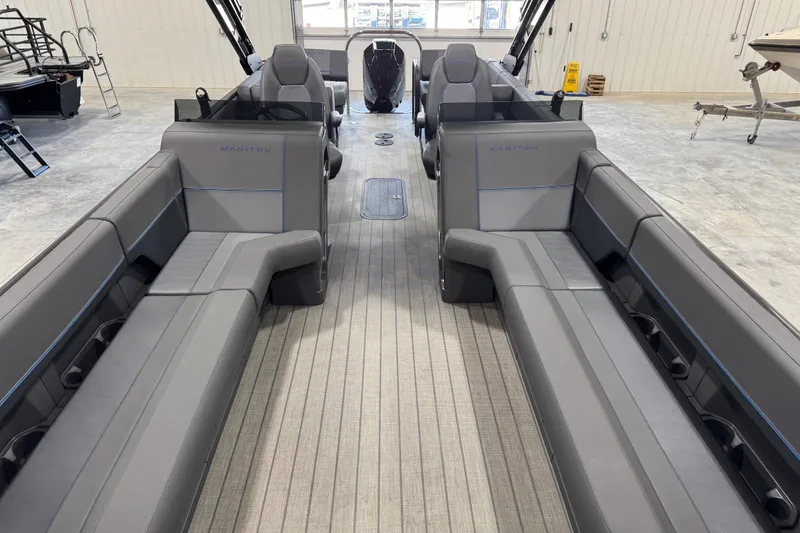 Slide: The Image of Interior of 2025 Manitou 26 Explore boat with sleek gray seating and modern design. - 12
