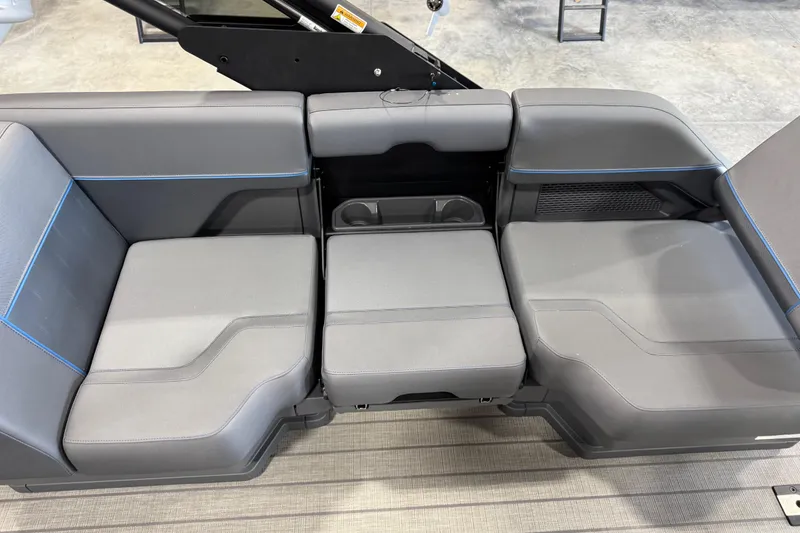 Slide: The Image of 2025 Manitou 26 Explore boat seating with modern gray upholstery and integrated cup holders. - 14