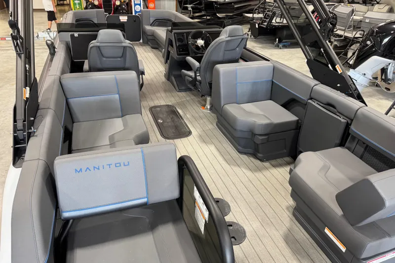 Slide: The Image of 2025 Manitou 26 Explore pontoon boat interior with modern seating and sleek design. - 15