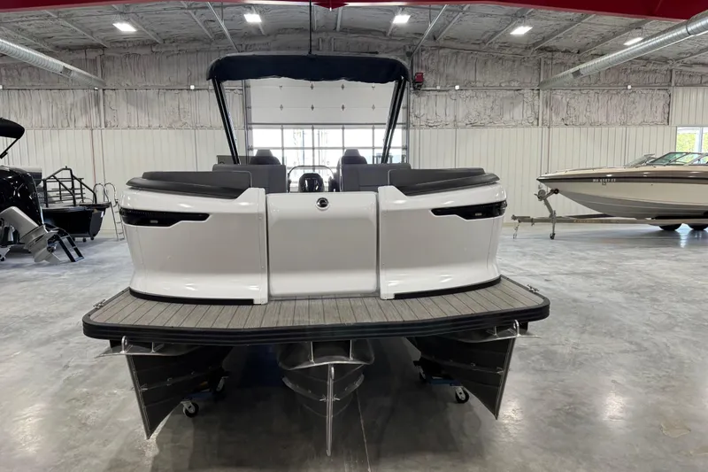 Slide: The Image of 2025 Manitou 26 Explore pontoon boat in a showroom, rear view. - 3