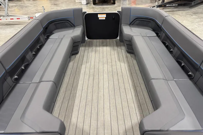 Slide: The Image of Interior of 2025 Manitou 26 Explore boat with spacious seating and modern design. - 9