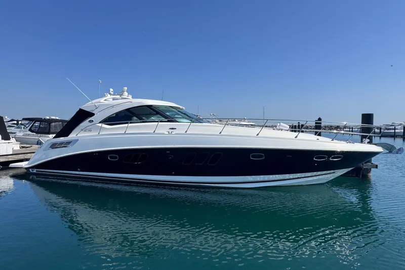The Image of 2011 Sea Ray 540 Sundancer yacht docked in a marina under clear blue skies. - 0