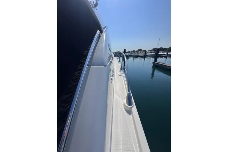 Slide: The Image of Side view of a 2011 Sea Ray 540 Sundancer yacht docked in a marina. - 11