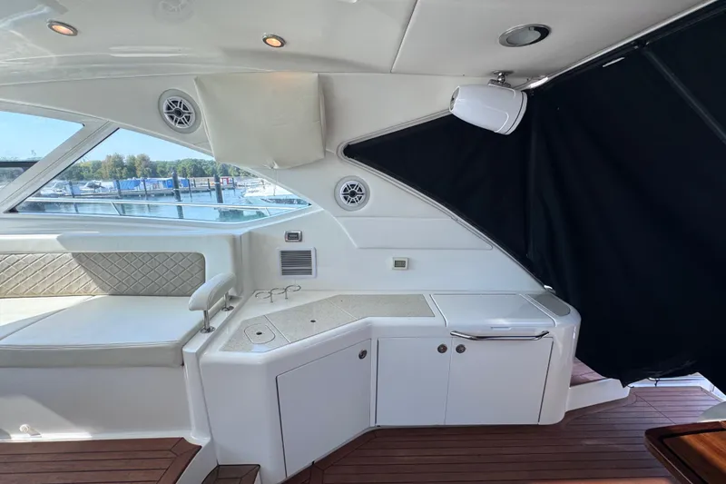 Slide: The Image of Interior of 2011 Sea Ray 540 Sundancer yacht with seating and kitchenette area. - 17