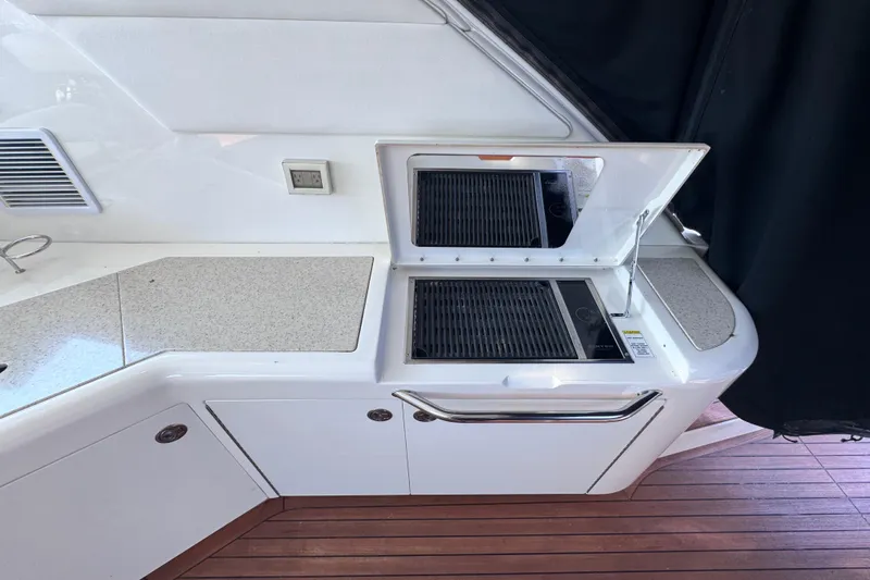 Slide: The Image of Outdoor kitchen area on a 2011 Sea Ray 540 Sundancer yacht with grill and countertop. - 19