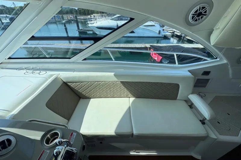 Slide: The Image of Interior view of 2011 Sea Ray 540 Sundancer yacht with luxurious seating and marina backdrop. - 26