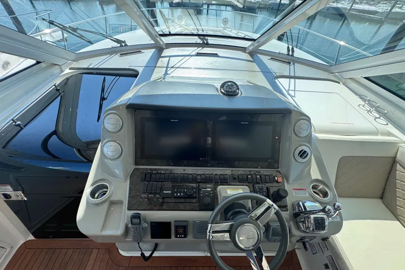 Slide: The Image of Helm of 2011 Sea Ray 540 Sundancer yacht with modern navigation controls and steering wheel. - 27
