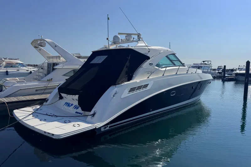 Slide: The Image of 2011 Sea Ray 540 Sundancer yacht docked in a marina under clear blue skies. - 3