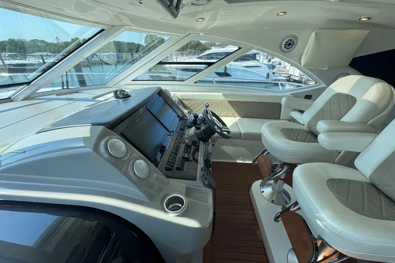 Slide: The Image of Luxurious 2011 Sea Ray 540 Sundancer yacht cockpit with plush seating and advanced controls. - 31