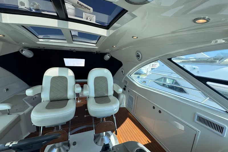 Slide: The Image of Luxurious interior of 2011 Sea Ray 540 Sundancer yacht with plush seating and panoramic windows. - 32