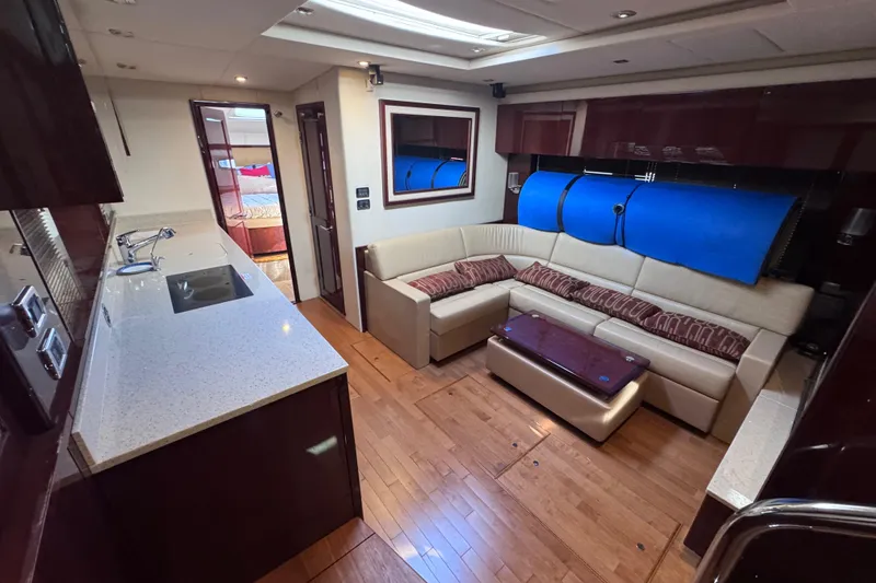 Slide: The Image of Luxurious interior of 2011 Sea Ray 540 Sundancer yacht with modern kitchen and seating area. - 38