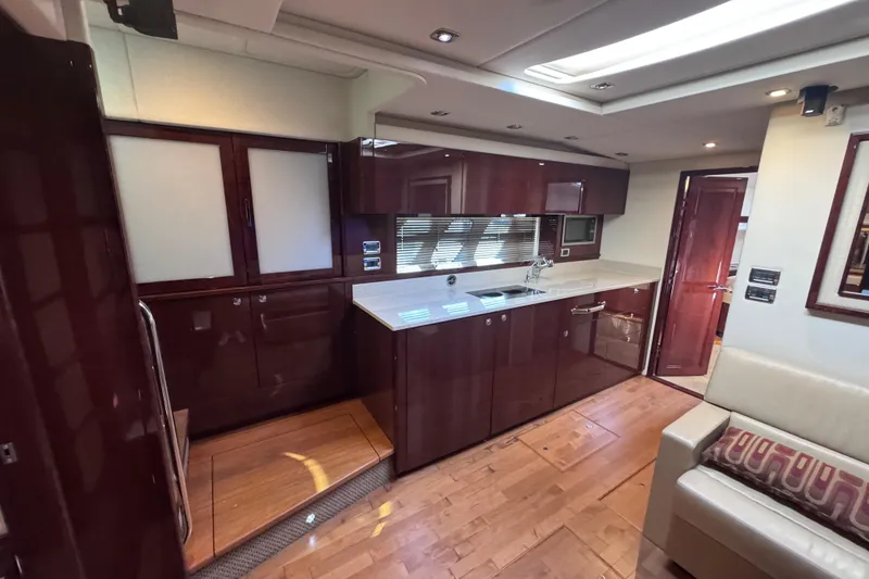 Slide: The Image of Luxurious interior of 2011 Sea Ray 540 Sundancer yacht with modern kitchen and seating area. - 39
