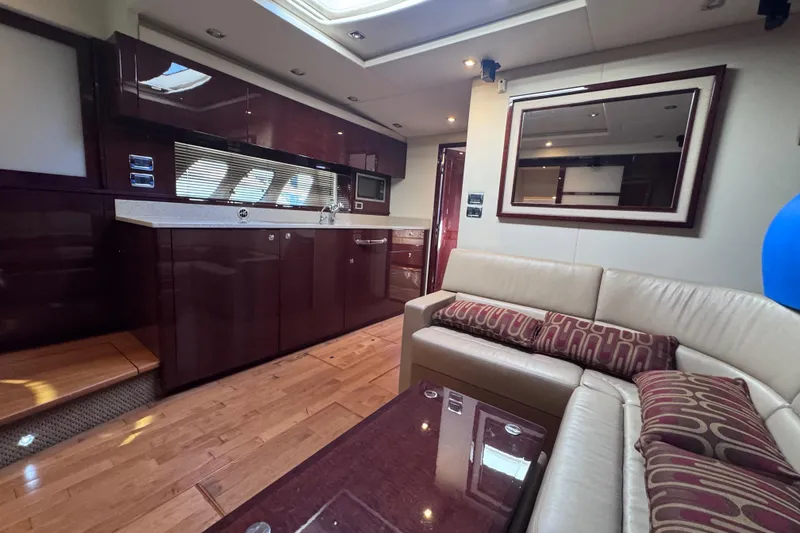 Slide: The Image of Luxurious interior of 2011 Sea Ray 540 Sundancer yacht with modern kitchen and seating area. - 41